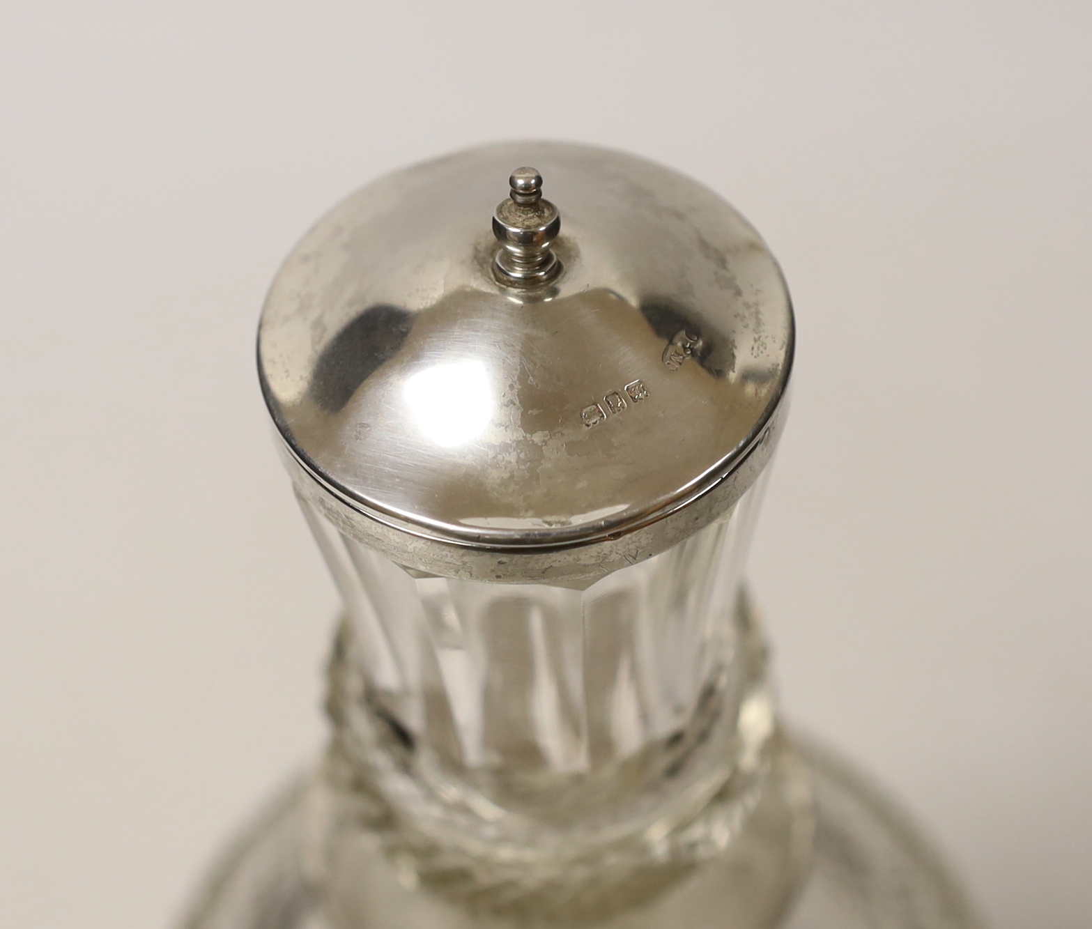 A George V silver mounted cut glass thistle shaped decanter and stopper, Wolfsky & Co Ltd, London, 1927, 29.5cm.